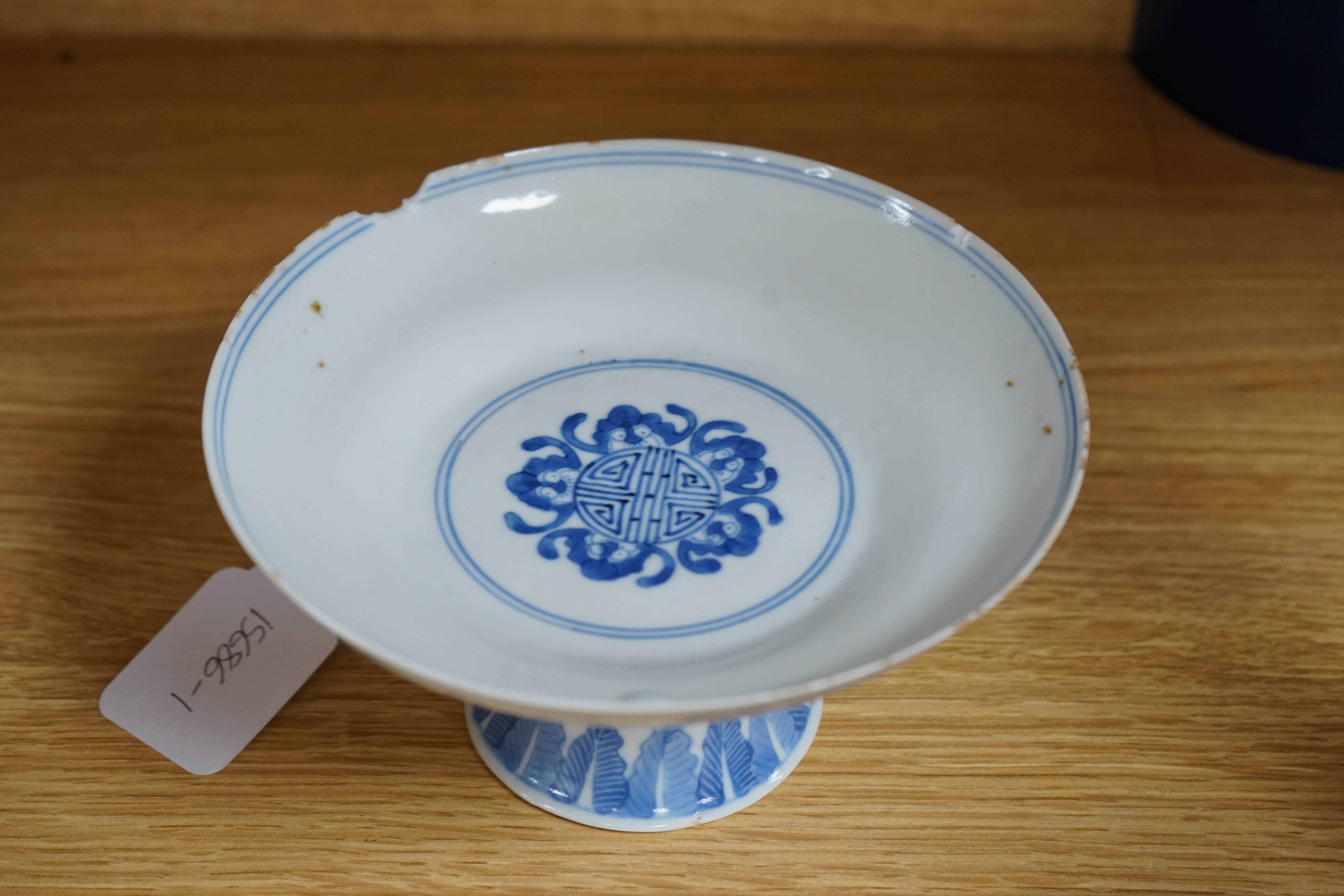 A Chinese blue and white stem dish, Kangxi mark, c.1900. Condition - poor to fair, some significant chipping to rim